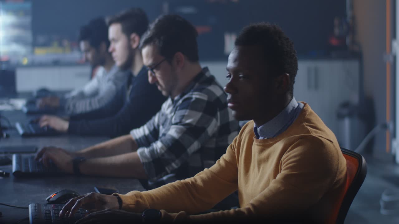 Team of programmers working at computers