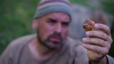 Man Holding Piece of Amber