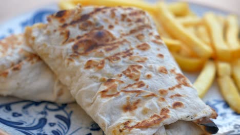 a delicious burrito with french fries