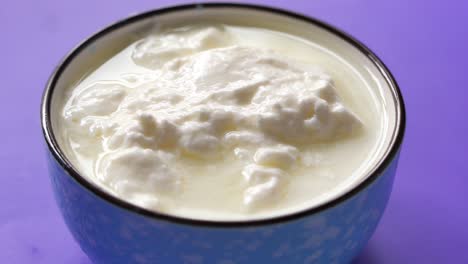 strained yogurt in a blue bowl