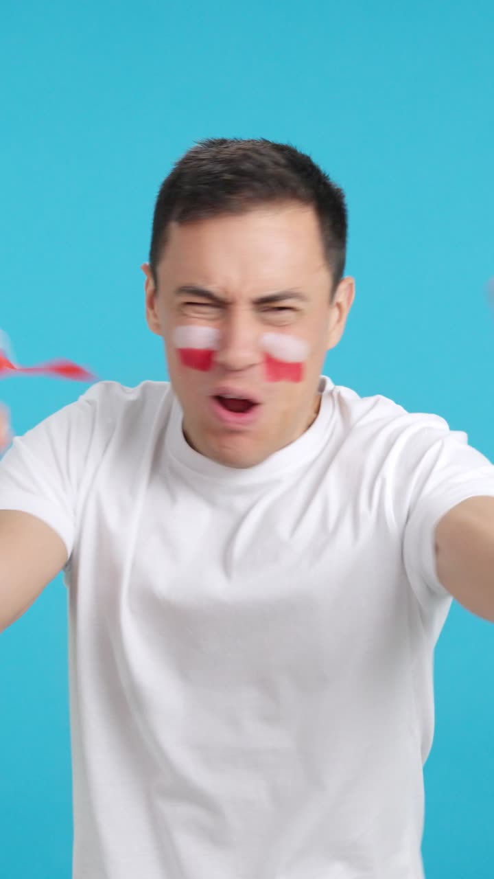 Man cheering for Poland screaming and waving a national flag