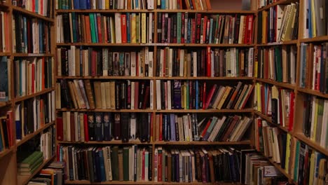 rows of old books on shelves in vintage book shop in inverness, scotland in the highlands