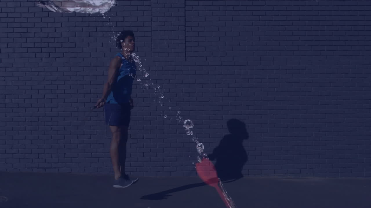 Person standing against brick wall with water splash animation over them