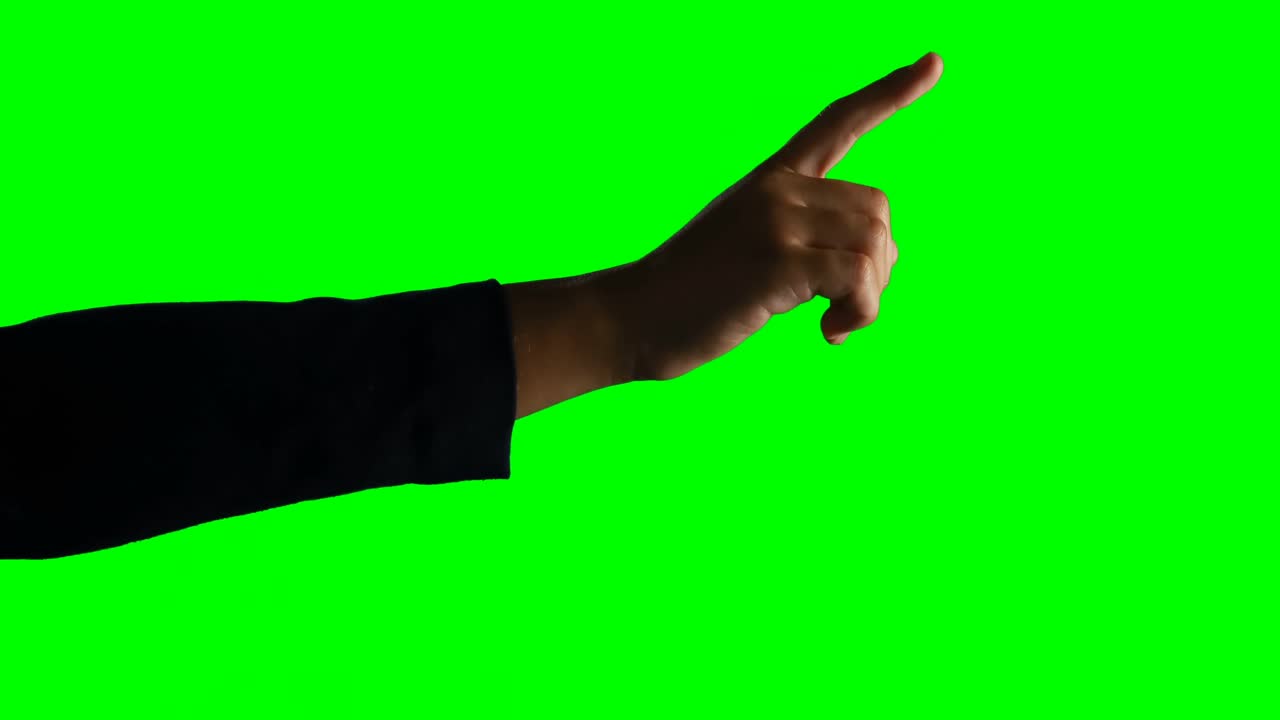 Person making hand gesture against green screen background