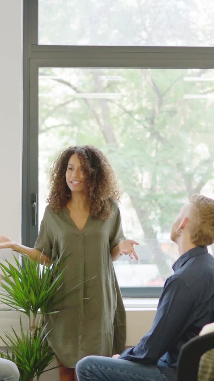 Manager presenting an idea to the employees in a coworking