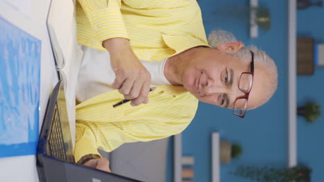 vertical video of home office worker old man funny and entertaining.