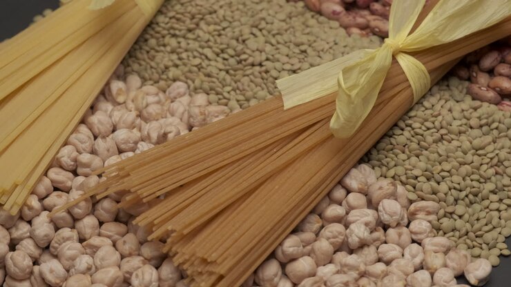 Integral wholemeal spaghetti pasta Italian Mediterranean food and mixed legumes dry beans, lentils, chickpeas rotating