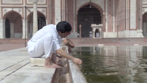 wuzu cleansing being done at a mosque by an indian muslim man