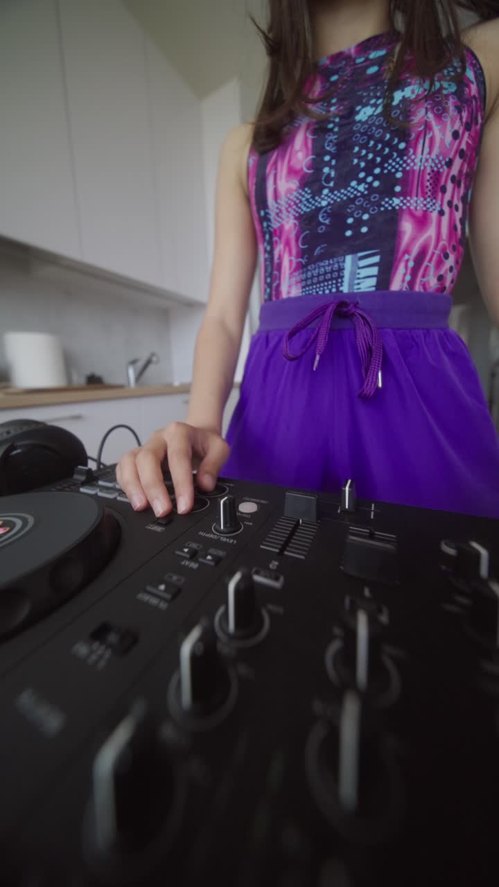 Young Woman Operating DJ Mixer at Home