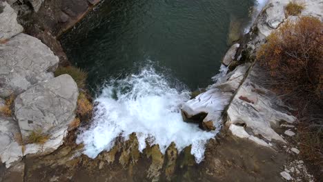 aerial top-down view over lundbreck falls in slow motion slowly ascending