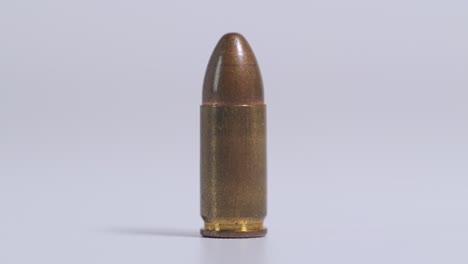 High detail pistol round showcased with cinematic motion on bright white studio