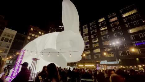 a giant 50 foot rabbit in downtown pittsburgh for the city's first night celebrations. pittsburgh downtown market square during christmas holiday season for art exhibit
