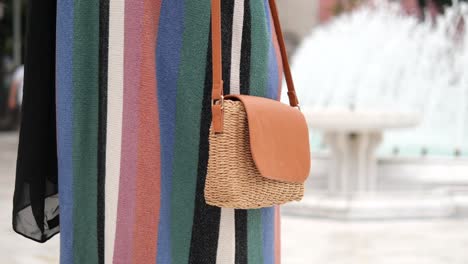 closeup of a brown straw crossbody bag