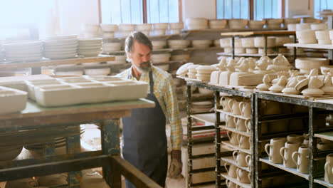 male potter checking pottery 4k