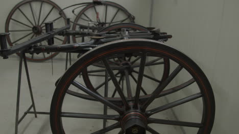 tilt up of large wheels and under carry of old carriage under restoration in workshop