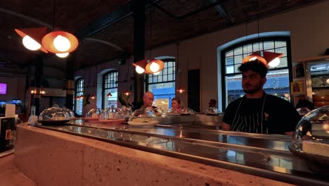 chef prepares desserts in bustling restaurant setting