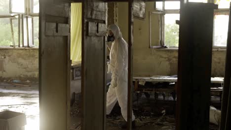 Worker-in-protective-suit-inside-the-ruined-building