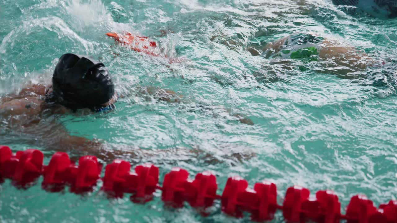 An Engaging Swimming Training Session Featuring a Family of Swimmers in a Training Pool, Showcasing Their Skills and Collaborative Spirit in the Water