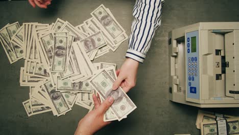specialised police officer counting dollar banknotes in crime lab, conceptual image. high quality 4k footage
