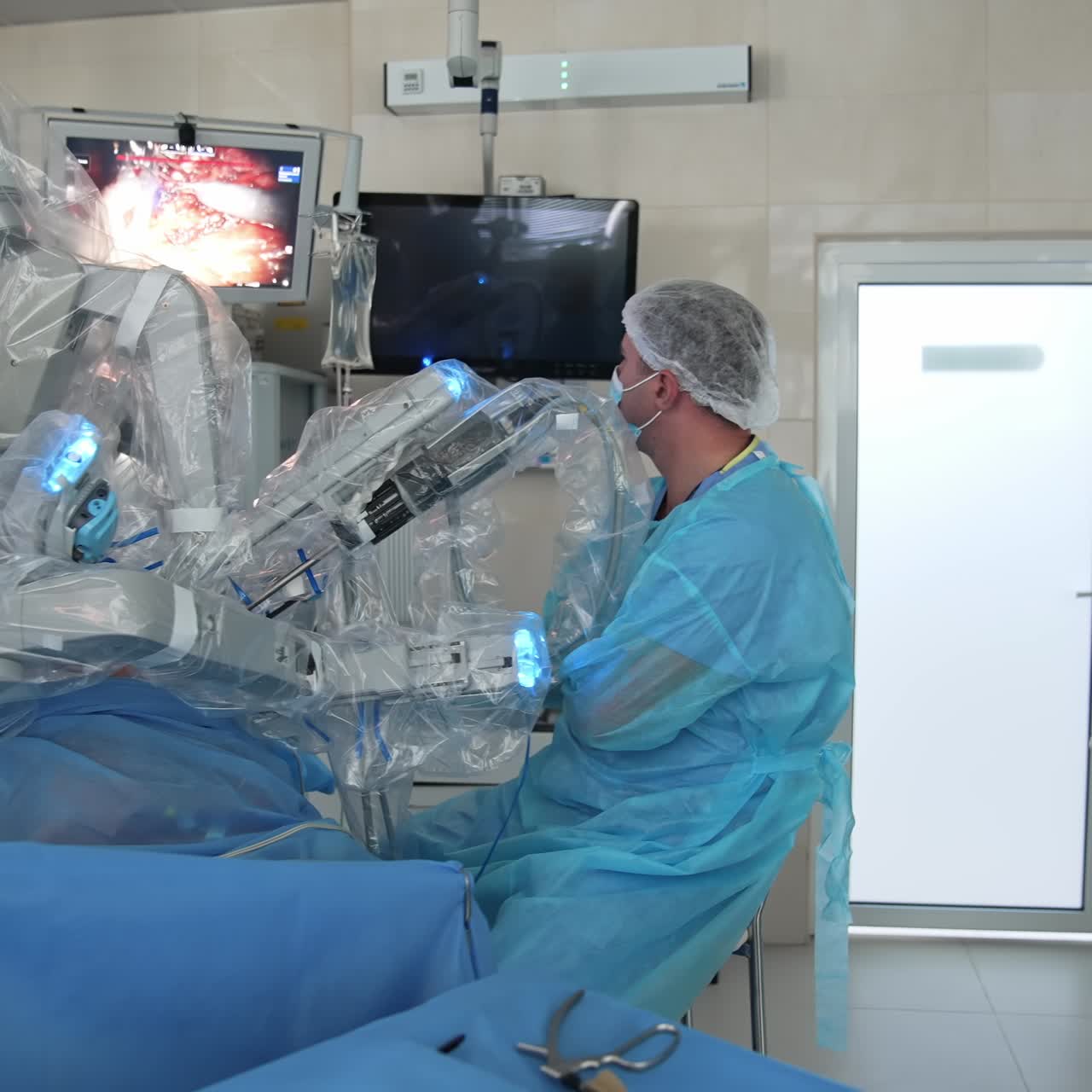 Microsurgery with robotic equipment. Surgeons observe the operation process on monitor of modern medical machine in hospital
