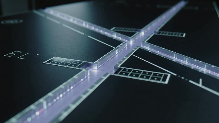 Tracking camera moving to center lit cross channels on glossy panel, revealing pulsing LEDs