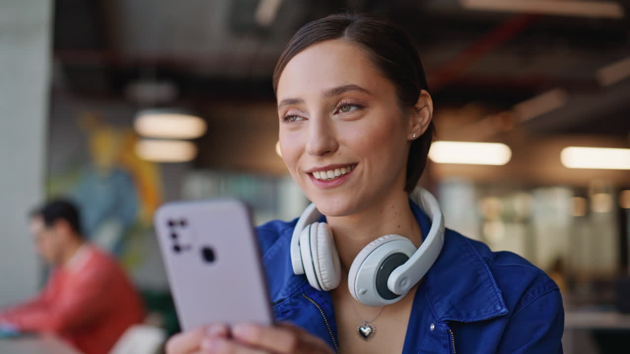 Lady hands texting cellphone in contemporary cafeteria closeup. Smiling woman