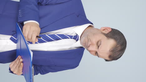 Vertical-video-of-Businessman-scratching-his-ear.