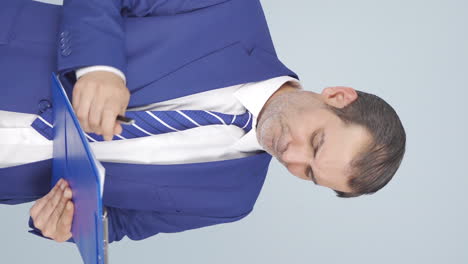 vertical video of businessman scratching his ear.