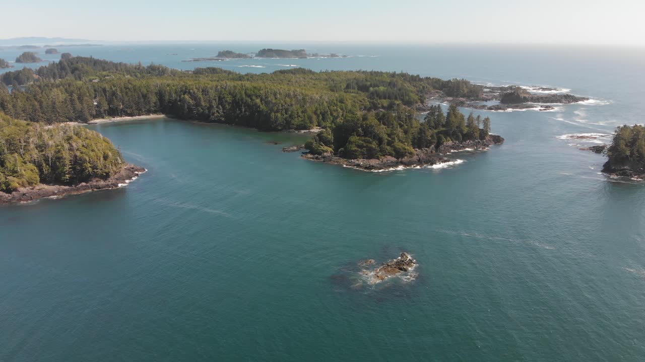 Aerial, smooth view above Vancouver Island in 4K. Ocean, rocks, forest, seaside. Ucluelet, British Columbia, Canada.
