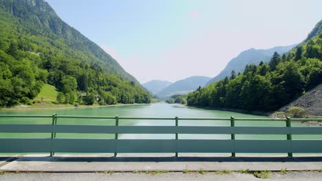 mountain biker rides across an alpine dam