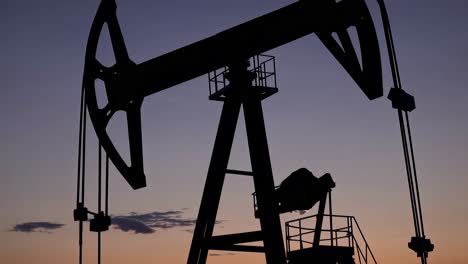 oil pump jack silhouette at sunset