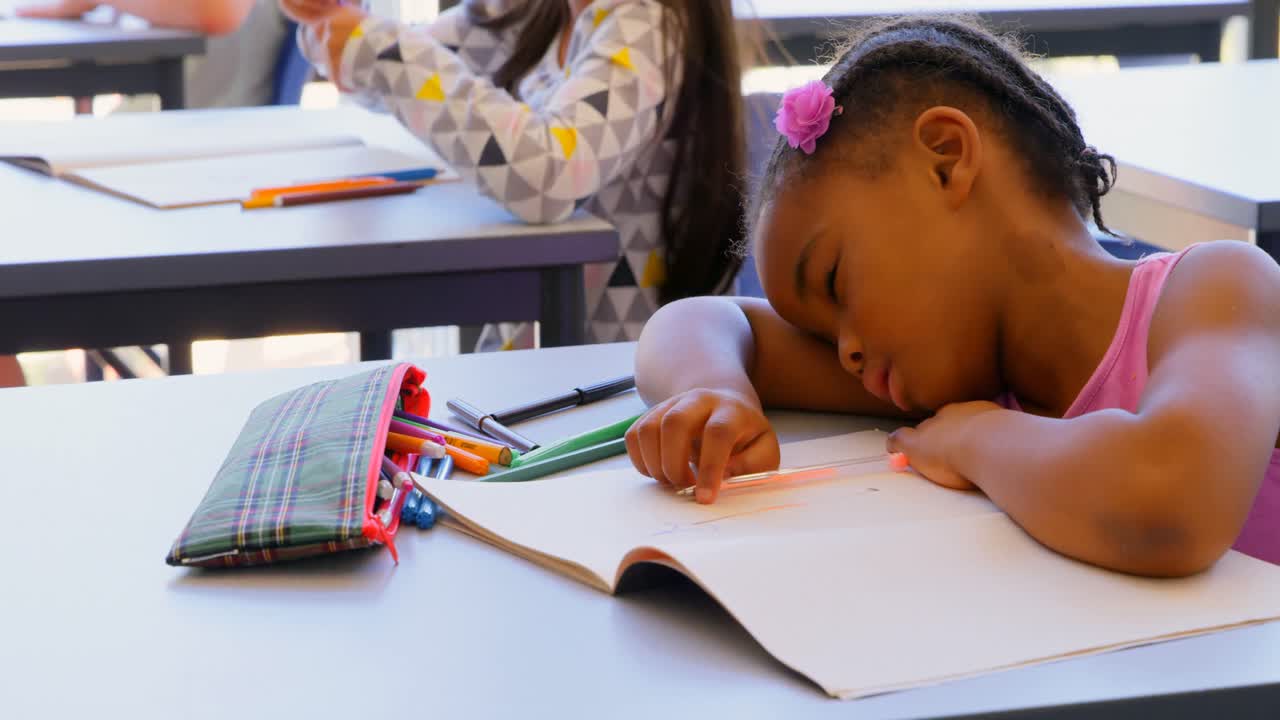 Schoolgirl sleeping on book at desk in the classroom 4k