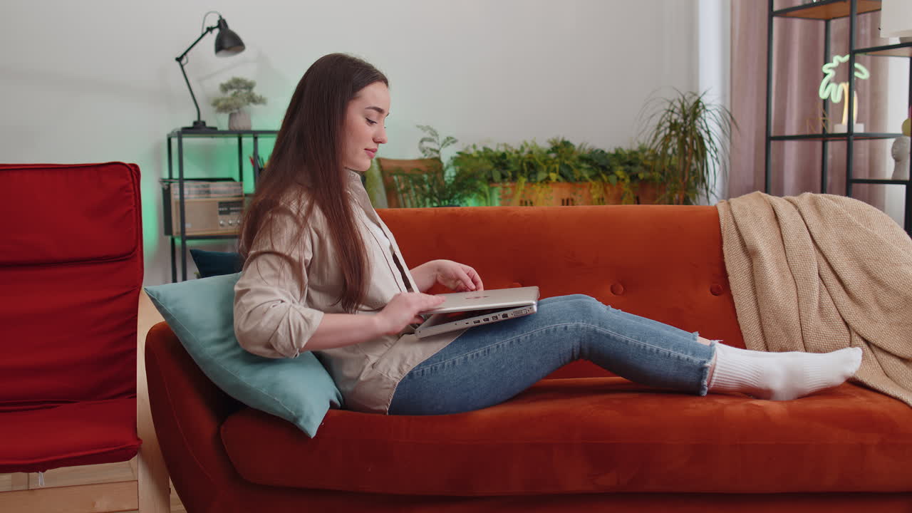 Pretty woman freelancer opens laptop starts working education sends messages makes online purchases