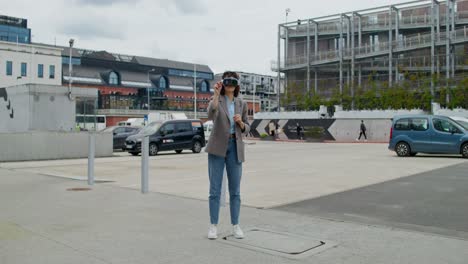 woman experiencing virtual reality in a city parking lot