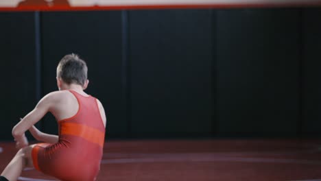 teenage wrestler working on his stance and motion drills during practice