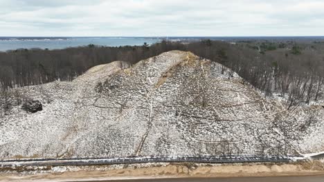 a large sand dune frozen with fresh snow