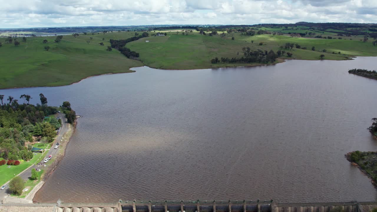 Reversing aerial footage over the dam wall of water being released from Lauriston Reservoir, in central Victoria. October 2022.