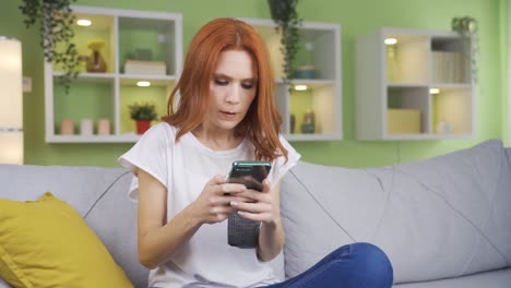 Frustrated-and-unhappy-woman-texting-on-the-phone-at-home.