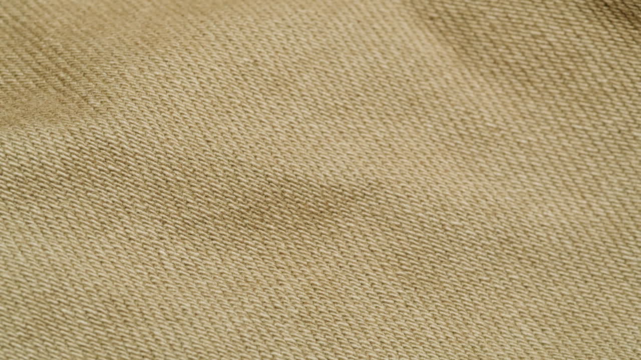 Close-up view of a beige fabric texture