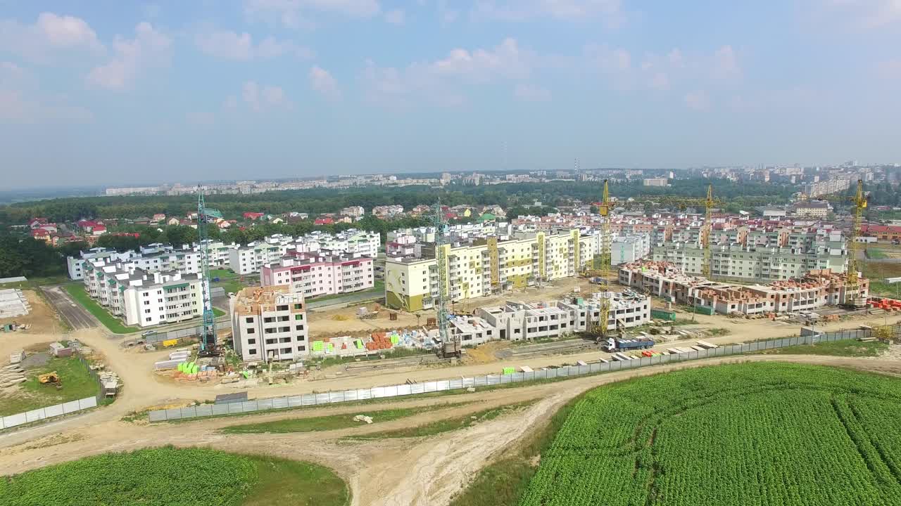 view of the construction of modern high-rise buildings on the background of the panorama of the city. Aerial view