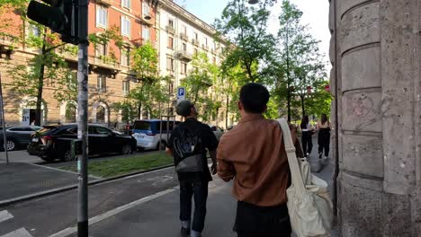 pedestrians walking along a street in milan