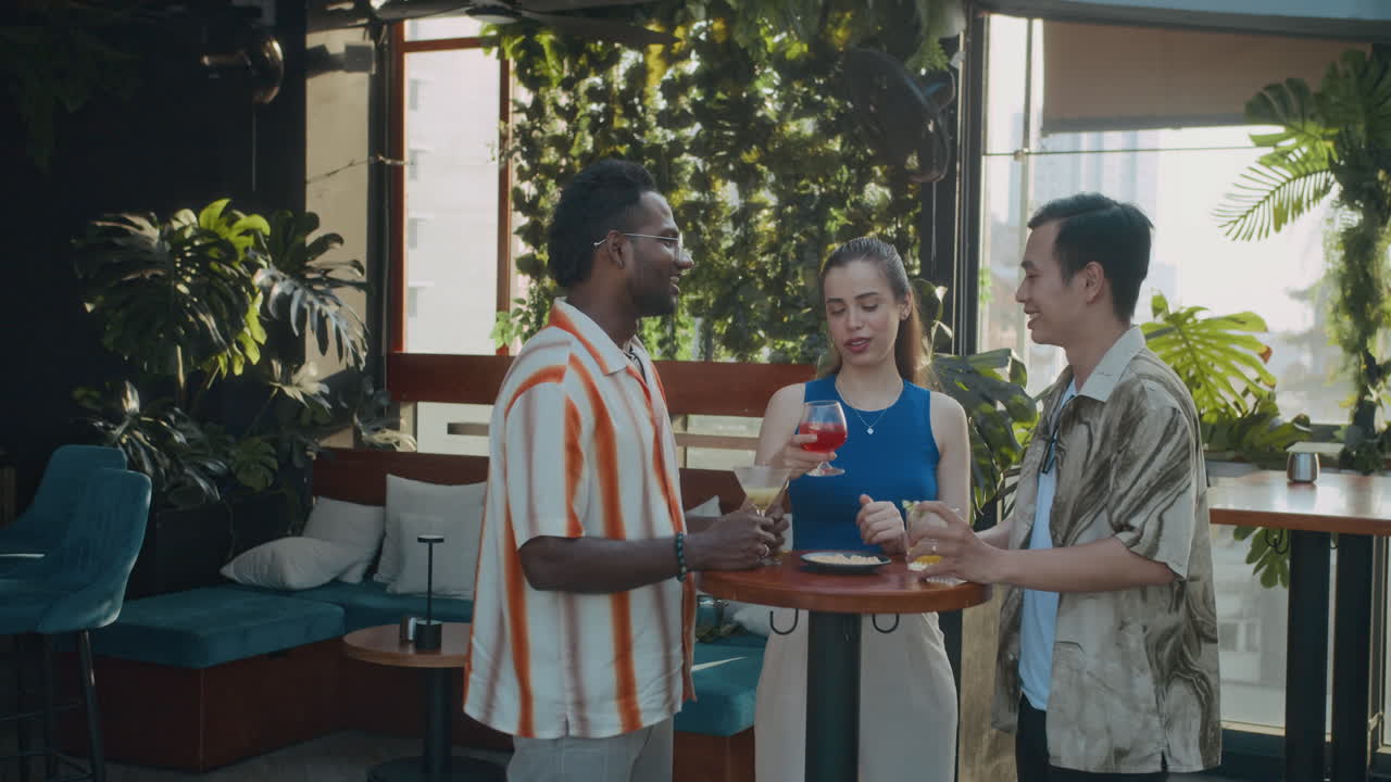 Diverse Colleagues Meeting at Bar to Have Drinks after work