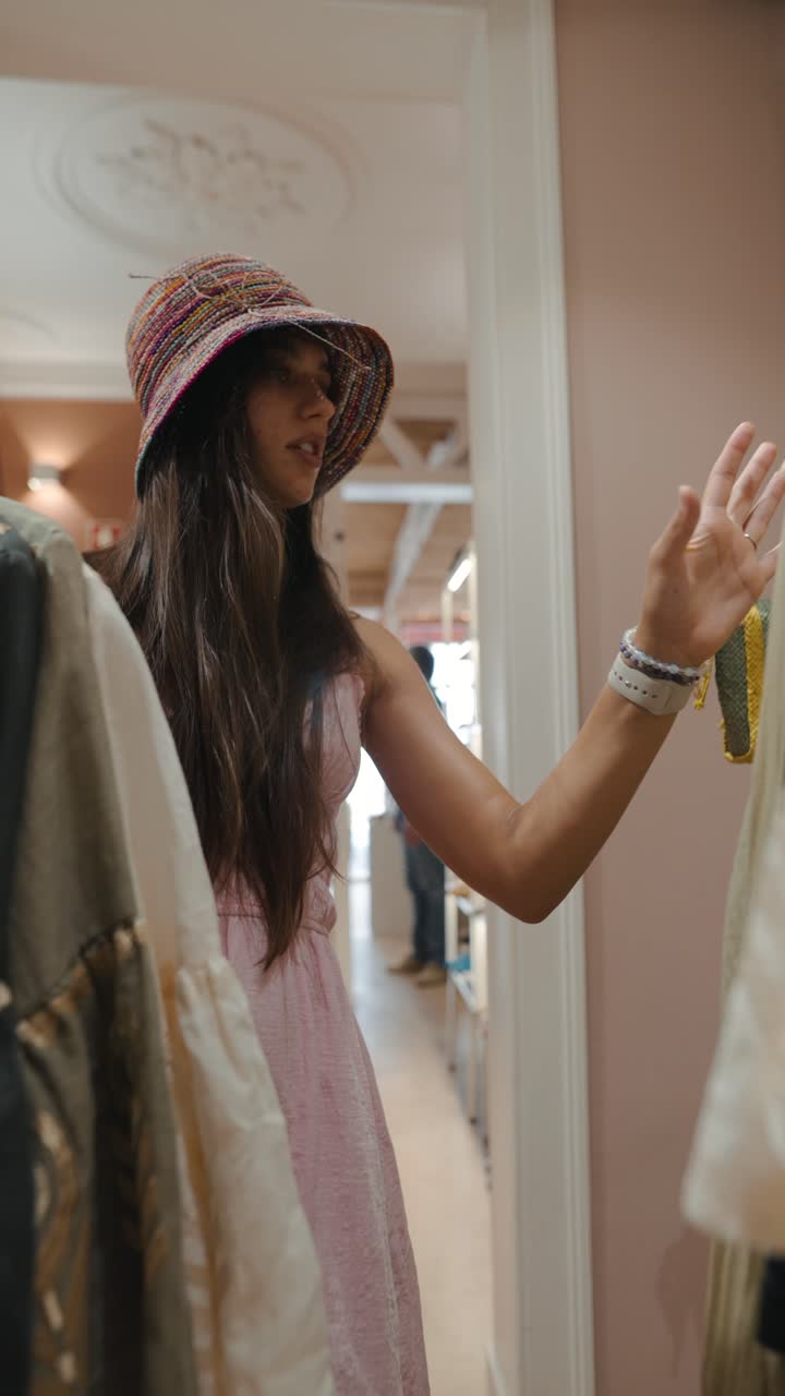 A woman looks at clothes in a store
