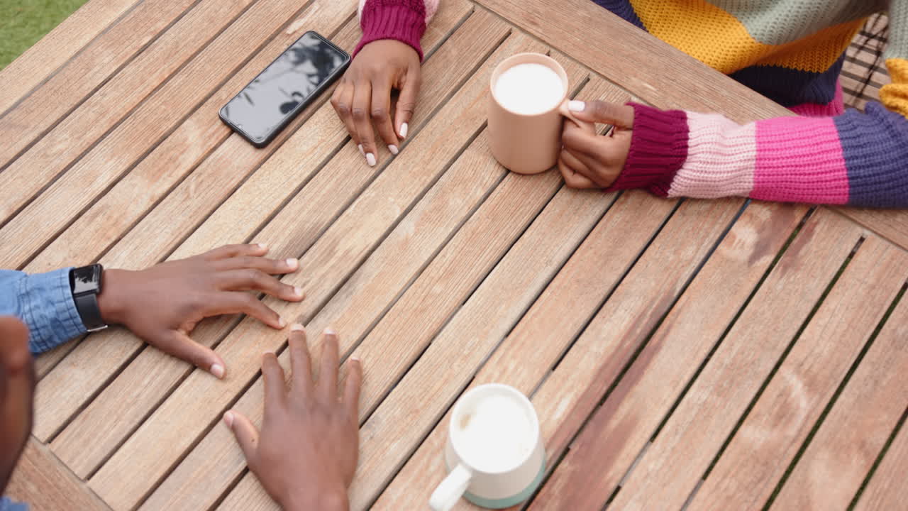 Holding hands and drinking coffee, african american couple enjoying time together at home