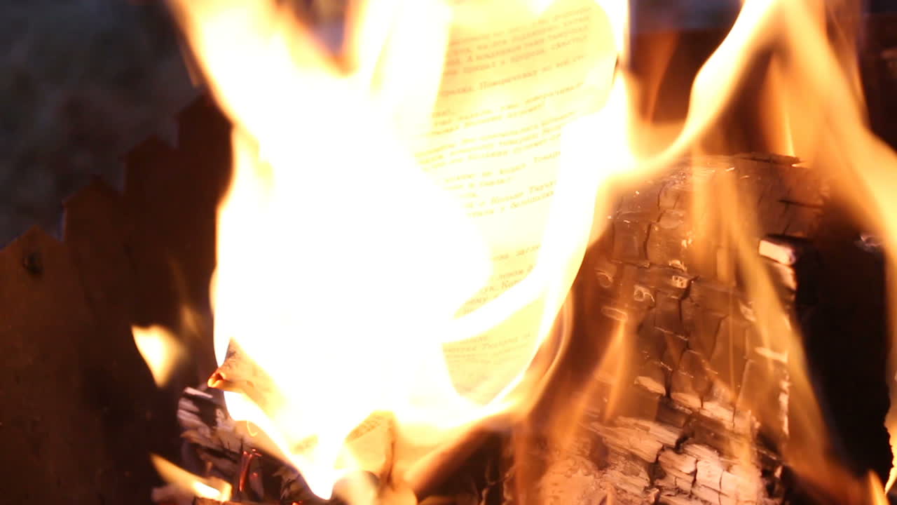 Paper Burning In Yellow Flame. Paper in bonfire with lots of trees burning in outdoor