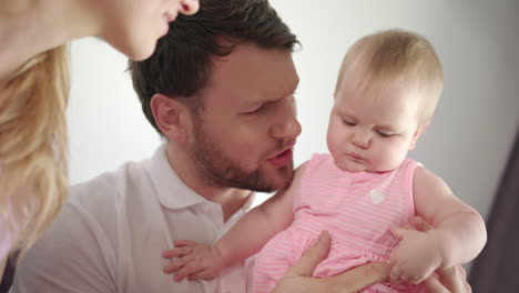 father kissing baby girl. dad kiss daughter infant at home. male tenderness