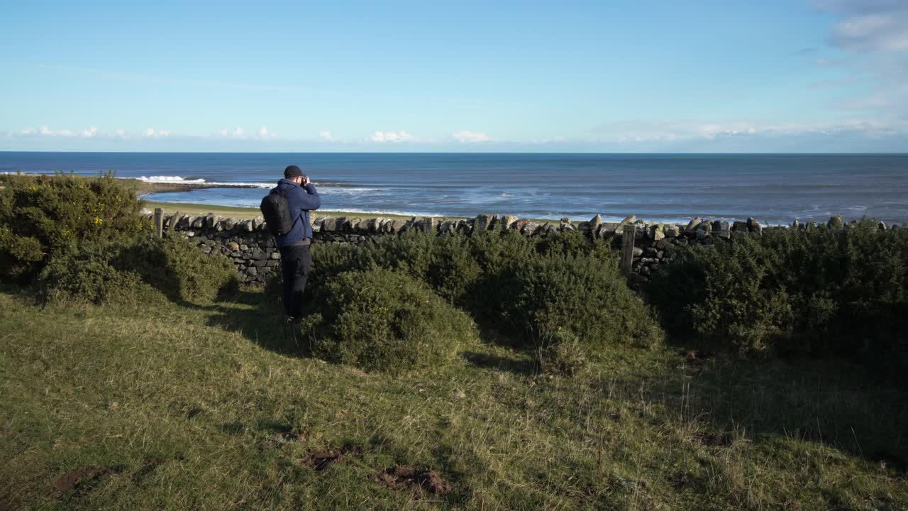 Photographer capturing the scenic coastal view