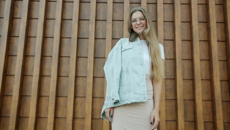 stylish woman posing in front of wood paneling
