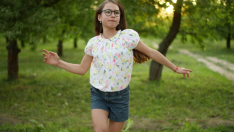 happy girl making having fun outdoors. teenage girl dancing outside.