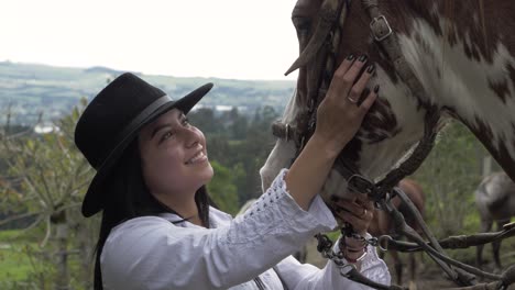 Petting-her-beautiful-brown-with-white-horse-in-the-mountains